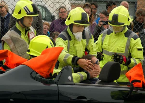 Firefighters carry out a demonstration on releasing a casualty from a traffic collision at a road safety awareness day at Melton Fire Station EMN-180110-105146001