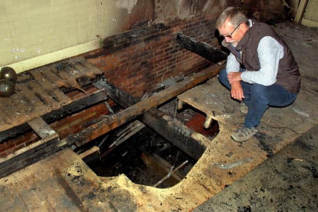 Chairman Brian Keevil inspects the fire damage at Hose village hall EMN-180110-111013001