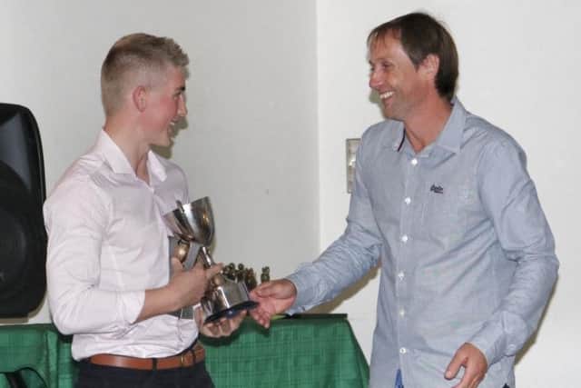 Jamie Tew receives one of his several awards from a familiar face - his dad Karl EMN-180310-153827002