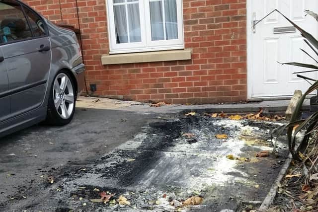 The charred and burned driveway of a property on Bramley Close, Melton where a car was set alight by an arsonist EMN-180810-112041001