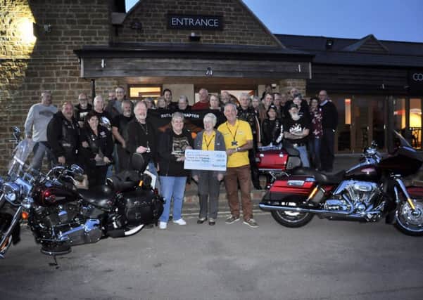 Ian and Valerie Snowdon, members of Rutland Chapter of HOG (Harley-Davidson Owners Group), and director Mike Grant handing over the cheque PHOTO: Supplied