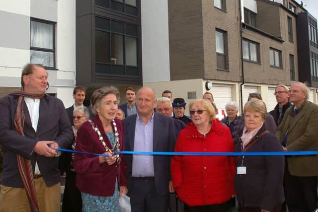 Mayor of Melton, Councillor Pru Chandler, cuts a ribbon outside the refurbished Beckmill Court flats in the town, flanked by Councillor Alan Pearson (left) and the leader, Councillor Joe Orson EMN-181026-142431001