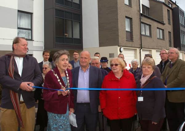 Mayor of Melton, Councillor Pru Chandler, cuts a ribbon outside the refurbished Beckmill Court flats in the town, flanked by Councillor Alan Pearson (left) and the leader, Councillor Joe Orson EMN-181026-142431001