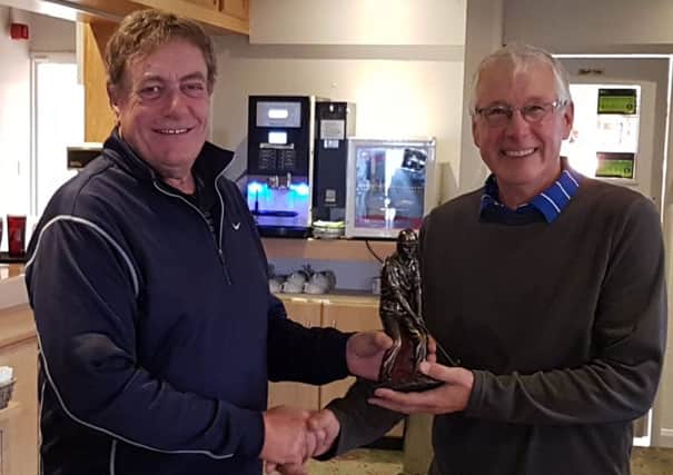 Melton Golf Club captain Glenn Price (left) presents the team challenge trophy to Jerzy Schmidt, captain of the winning Seniors team EMN-180611-164635002