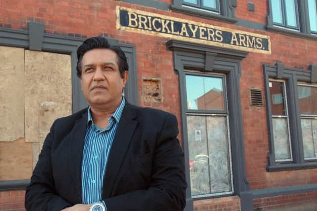 Atul Dawda pictured outside the old Bricklayer's Arms in Melton in March last year as work started on the renovation of the former pub to convert it into an Indian restaurant EMN-180911-110649001