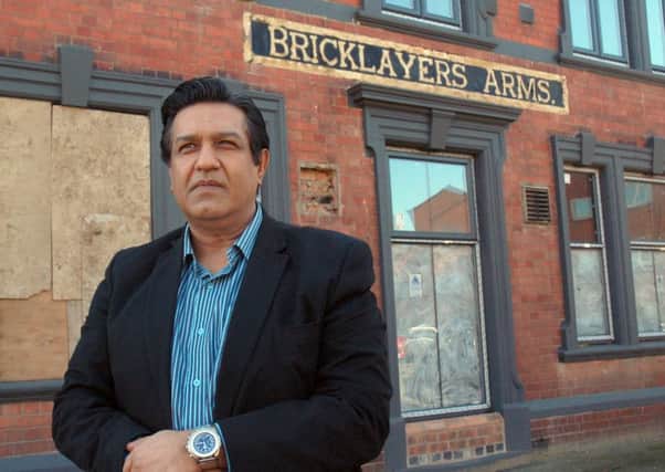 Atul Dawda pictured outside the old Bricklayer's Arms in Melton in March last year as work started on the renovation of the former pub to convert it into an Indian restaurant EMN-180911-110649001