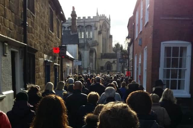 Church Street is fillled with people as they make their way to the Remembrance Sunday service at St Mary's Church in Melton EMN-181111-154137001