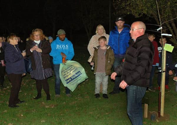 Asfordby FC chairman Simon Atherley with Will's family by the memorial tree and plaque EMN-181114-085205002