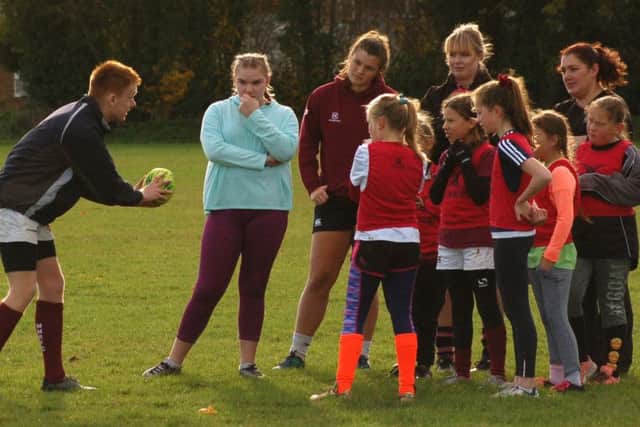 Ollie Jakes coaches girls at the first girls' rugby training session EMN-181116-124958002