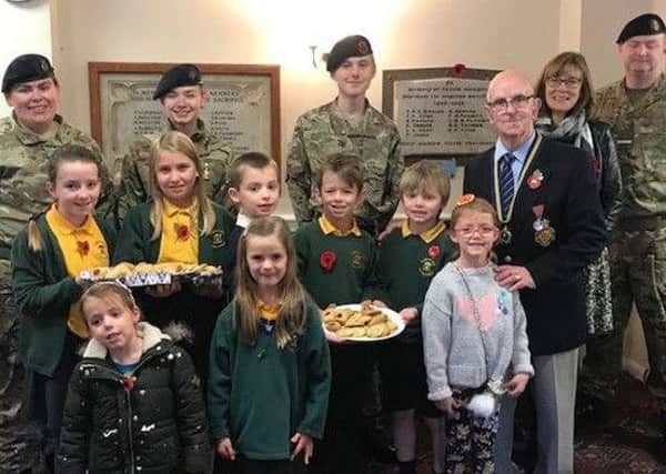 Pupils offer cookies to Remembrance Day parade helpers PHOTO: Supplied