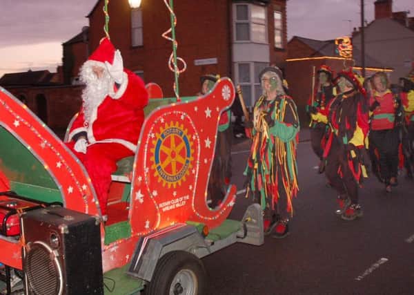 Santa arrives with a parade of morris men at a Syston Christmas Event PHOTO: Tim Williams