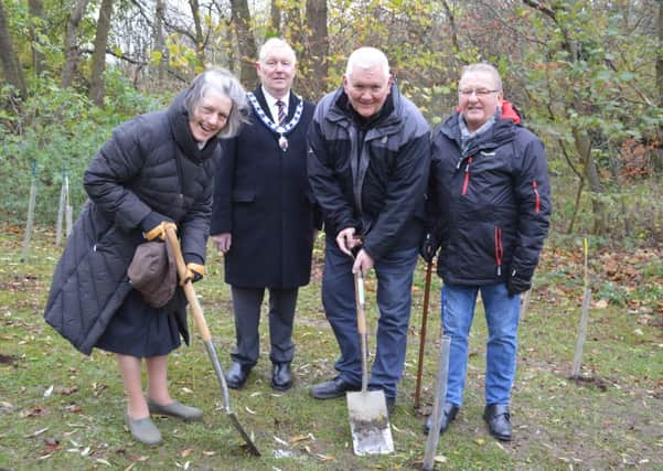 Senior Townwarden, John Southerington (centre), watches the presidents of Melton's three Rotary clubs, start planting more than 100 trees in Priors Close park EMN-181126-145654001