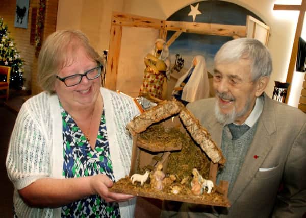 Carol Scarborough and John Phillips admire Ray Jackson's wooden crib creation PHOTO: Tim Williams