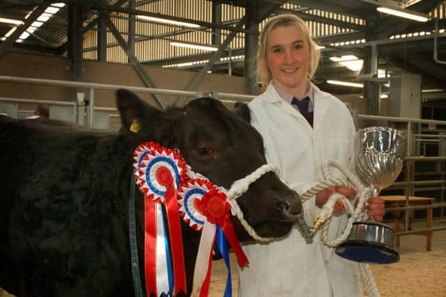 Charlotte Davies, of Top Field Farm, Gaddesby, with Pippa, her Belgian Blue Cross Limousin, which was named Champion Beast at the 2018 Christmas Fatstock Show and Sale EMN-180412-165019001