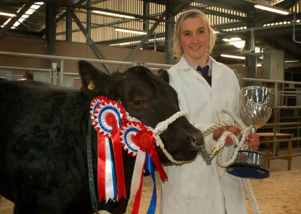 Charlotte Davies, of Top Field Farm, Gaddesby, with Pippa, her Belgian Blue Cross Limousin, which was named Champion Beast at the 2018 Christmas Fatstock Show and Sale EMN-180412-165019001