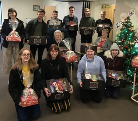 College students present their Christmas hampers at Gloucester House, Melton PHOTO: Supplied