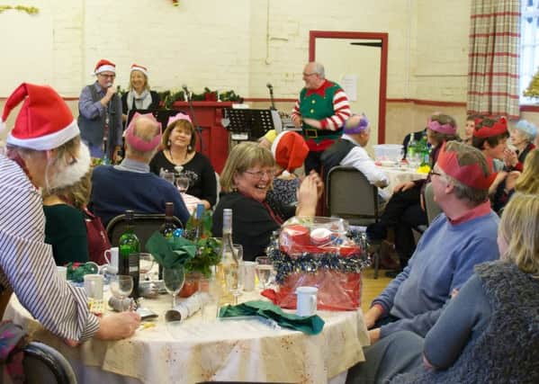 Old Dalby residents appreciate entertainment by The Elves at their Christmas lunch in the village hall PHOTO: Supplied
