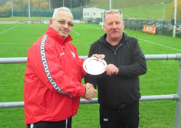 Club chairman Phil Baker presents a plaque to Monaghan chairman Ronan Callan to mark the clubs friendship EMN-181218-152512002