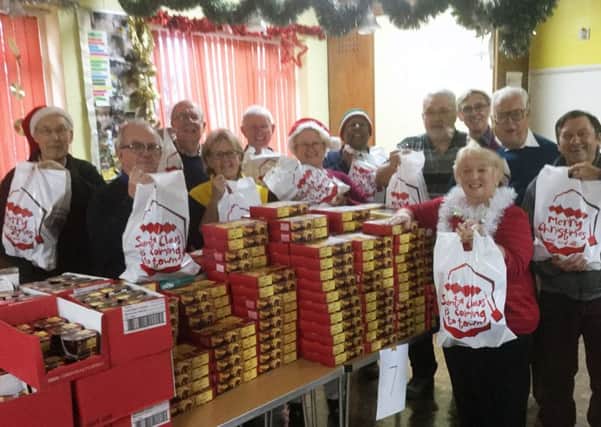 Lions and Rotarians preparing the Christmas food parcels PHOTO: Supplied