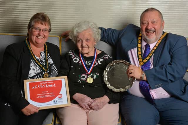 Pat Griffiths, (93), receives the award for first place in The Twilight Games on behalf of The Amwell, from Jenny and Ozzy O'Shea, chairman of Leicestershire County Council PHOTO: John Robertson