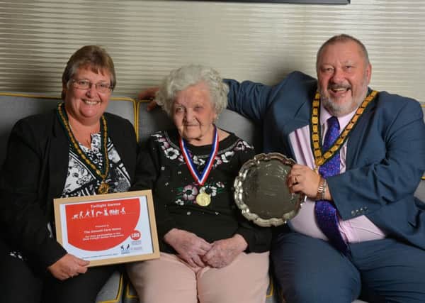 Pat Griffiths, (93), receives the award for first place in The Twilight Games on behalf of The Amwell, from Jenny and Ozzy O'Shea, chairman of Leicestershire County Council PHOTO: John Robertson