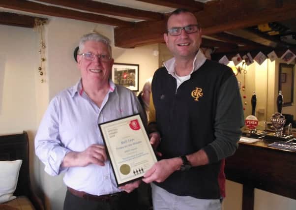 Robert Smith, landlord at The Bell pub at Frisby, received a coveted merit award from Melton CAMRA chairman Kevin Billson EMN-190301-155305001