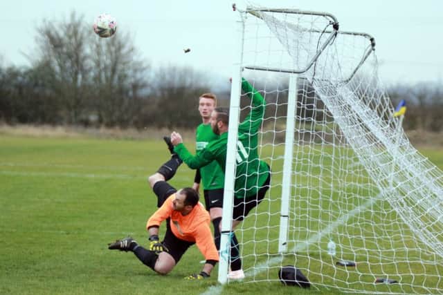 The Dons keeper and two defenders are helpless to keep out a Bottesford strike PICTURE: Robert Campion EMN-190801-124706002