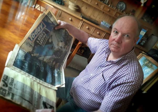 Former Melton police officer Phil Frier looks through the scrapbook he has kept with press cuttings from the Kegworth air disaster, where he was involved in the rescue effort in 1989 EMN-190901-092354001