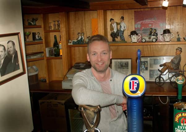 Landlord Callum McIver with some of the Laurel and Hardy memorabilia at The Bull Inn, at Bottesford EMN-190116-091613001