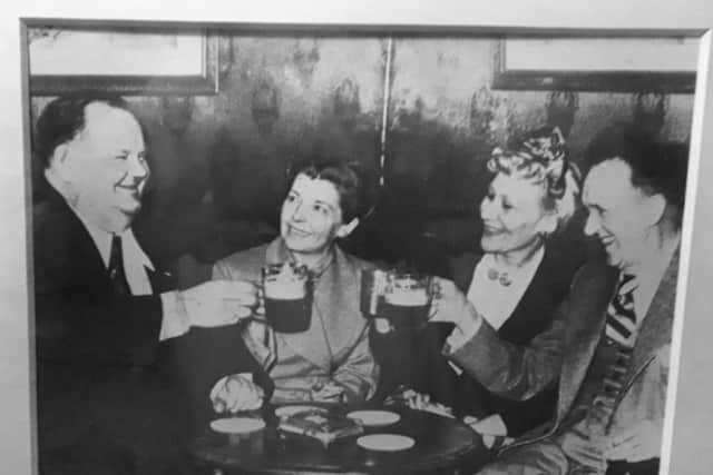 A photo of comedy legends Stan Laurel and Oliver Hardy visiting The Bull Inn at Bottesford in 1952 with their wives EMN-190116-091602001
