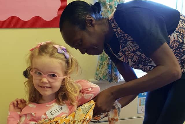 Ellie gets a helping hand from Bemma changing into African dress PHOTO: Supplied