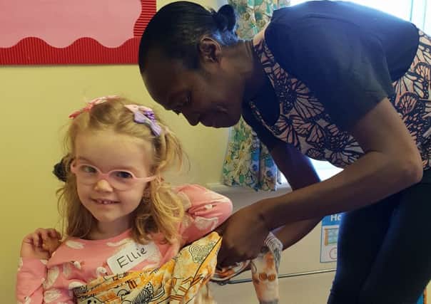 Ellie gets a helping hand from Bemma changing into African dress PHOTO: Supplied