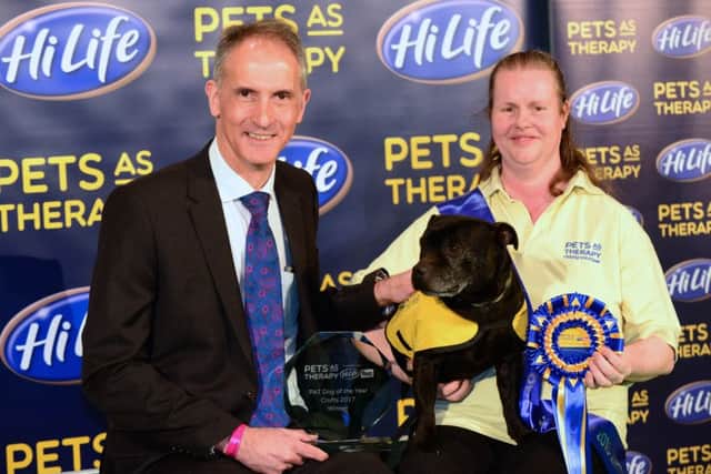 Town & Country Petfoods managing director Tony Parkinson, left, presenting the trophy to HiLife PAT Dog of the Year Winner 2017 Angie and her dog Sausage at Crufts.