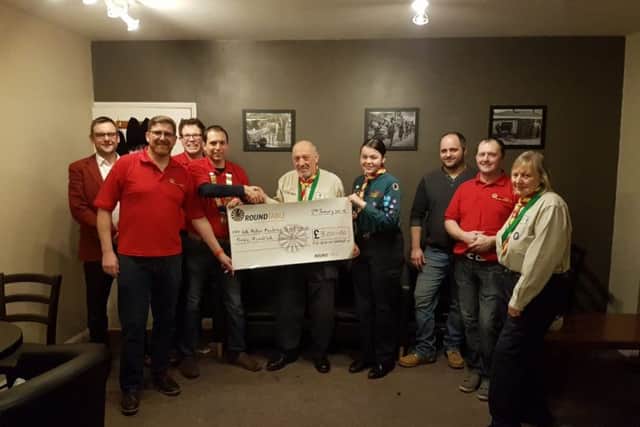 Mike Gant of 4th Melton Scouts receives a cheque for £300 from chairman Mark Cook and other members of Melton Mowbray and District Round Table PHOTO: Supplied