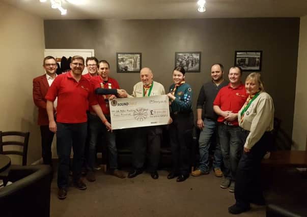 Mike Gant of 4th Melton Scouts receives a cheque for £300 from chairman Mark Cook and other members of Melton Mowbray and District Round Table PHOTO: Supplied