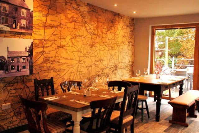 The restaurant with prints on the wall showing the pub as it looked in byegone years PHOTO: Tim Williams