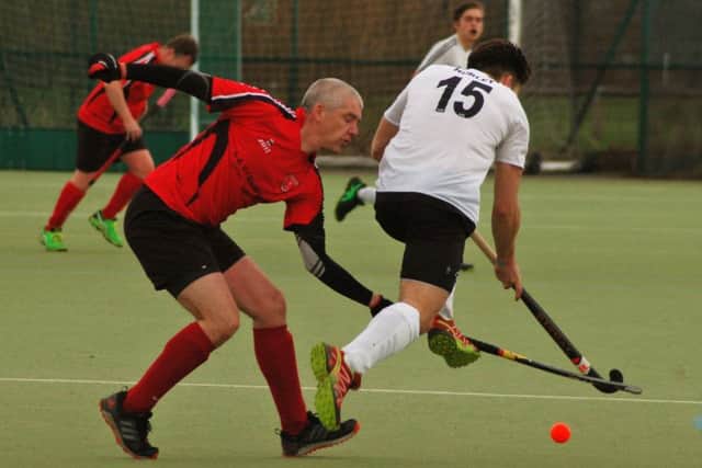 Pete Frederick makes a challenge for Melton Seconds in their 8-0 home defeat to Market Harborough First XI EMN-190129-112546002