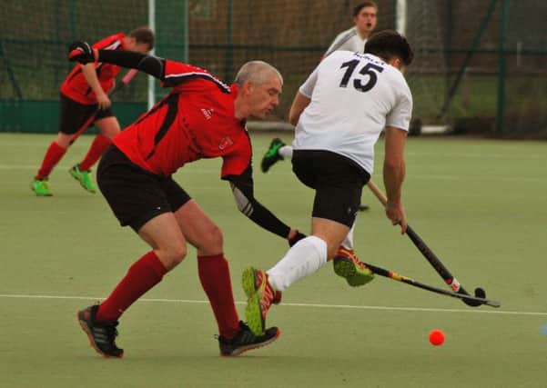 Pete Frederick makes a challenge for Melton Seconds in their 8-0 home defeat to Market Harborough First XI EMN-190129-112546002