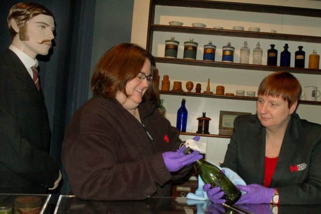 Zara Matthews and Amy Barr clean exhibits in the recreated Attenburrow Chemists at Melton Carnegie Museum EMN-190129-150721001
