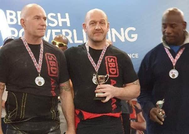 Jason Talbot (centre) wins his first British powerlifting title in 15 years EMN-190131-144201002