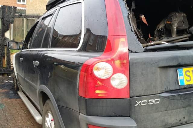 The back of the Nairn family's burned out Volvo which was destroyed in an arson attack in Drummond Walk, Melton, with the charred fencing in front of the vehicle EMN-190402-141503001