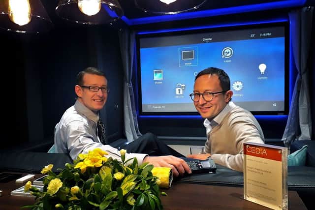 Director Richard Westmoreland and guest Charlie Reading sample the home cinema experience centre.