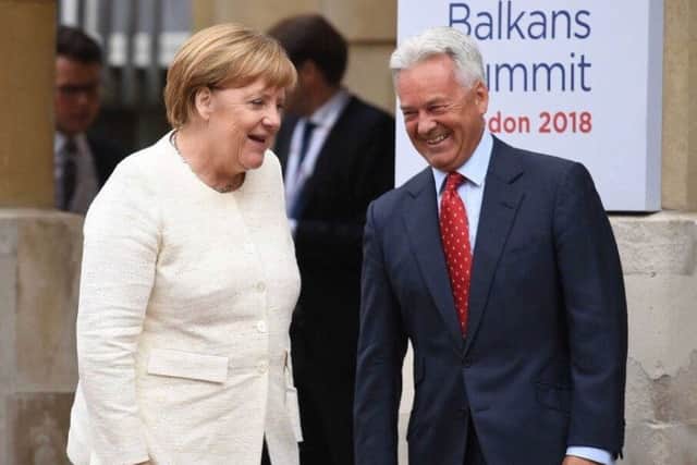 Sir Alan Duncan greets Chancellor Merkel on her arrival at the Western Balkans Summit last summer PHOTO: Supplied EMN-190502-180839001