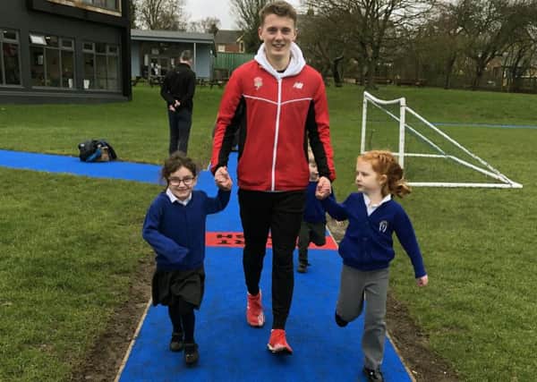 GB athlete Ben Higgins with pupils of Whissendine Primary School as he launched its new Daily Mile track EMN-190802-121739001