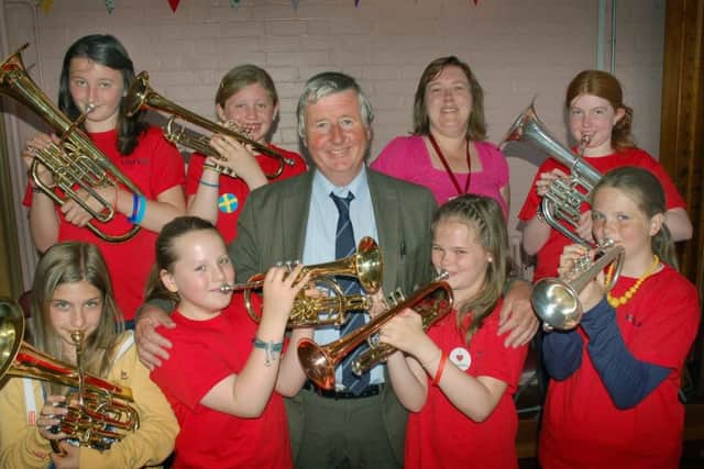 Brownlow Primary School teacher Fred Parker pictured with some of his brass instrument pupils and one of his former pupils, fellow teacher Kirsten Smith, on his retirement day in July 2013
PHOTO: Tim Williams EMN-190802-182209001