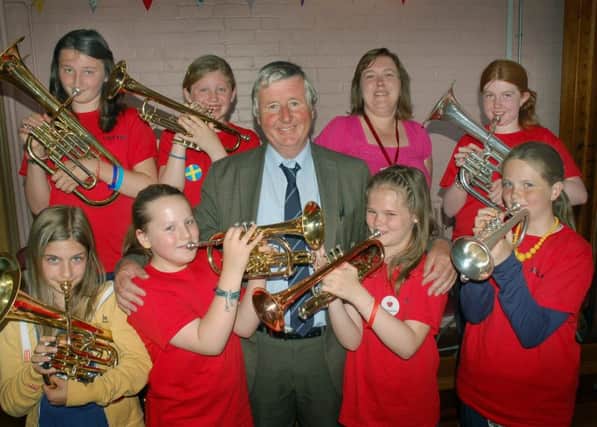 Brownlow Primary School teacher Fred Parker pictured with some of his brass instrument pupils and one of his former pupils, fellow teacher Kirsten Smith, on his retirement day in July 2013
PHOTO: Tim Williams EMN-190802-182209001