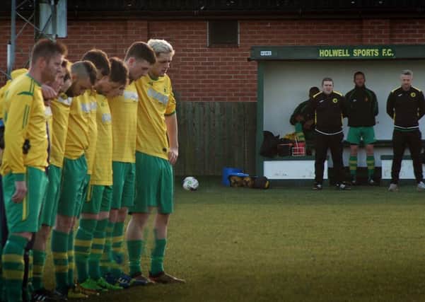 Holwell Sports players line up for a minute's silence for Ian Wakefield ahead of Saturday's match with Aylestone Park EMN-191202-100358002