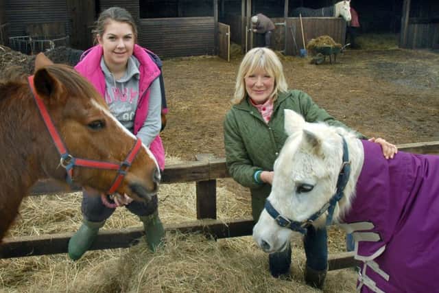 Carole Fielding with volunteer Jade Townend and a couple of resident ponies at Pablo's Horse Sanctuary PHOTO: Tim Williams EMN-190228-121133001