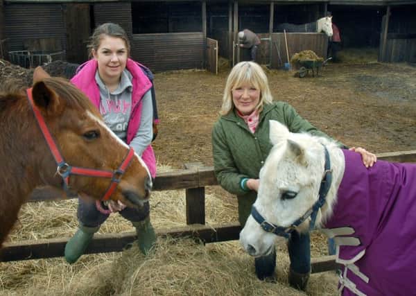 Carole Fielding with volunteer Jade Townend and a couple of resident ponies at Pablo's Horse Sanctuary PHOTO: Tim Williams EMN-190228-121133001