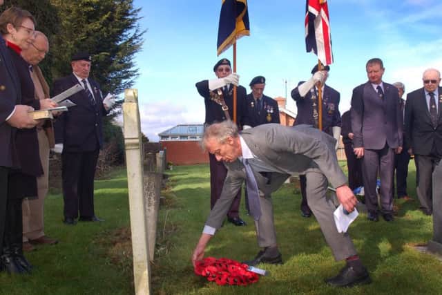 Distant family member of Alfred Marshall, David Isom lays a wreath EMN-190403-175643001